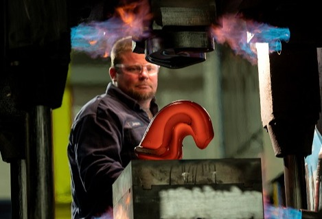 Machine shop utilizes forging press to reduce costs of titanium parts