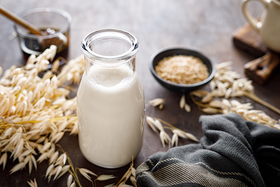 shutterstock_1782222443 - Vegan oat milk in glass bottle and ingredients.jpg